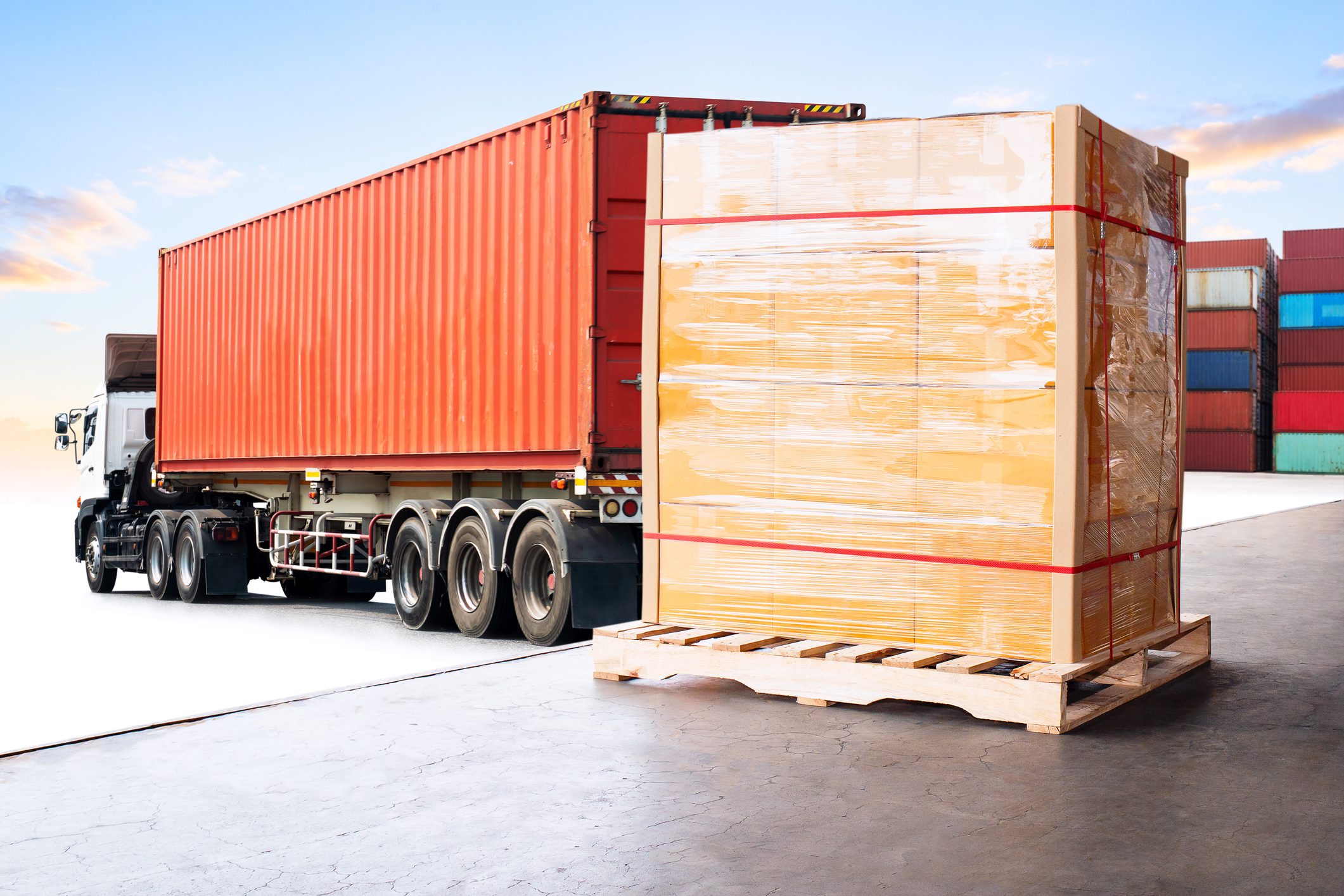 Truck with large shipping container and pallet.