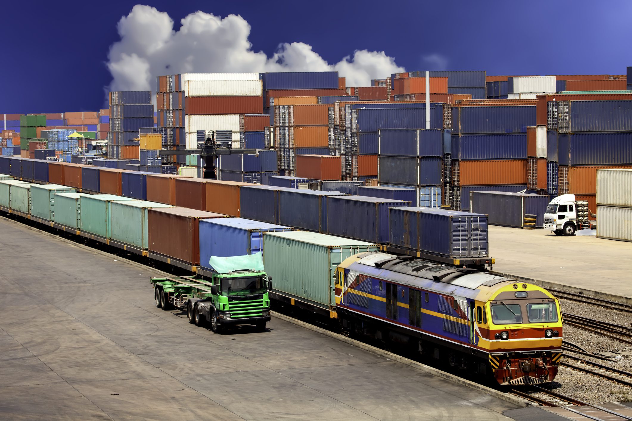 Freight train and truck at container terminal.
