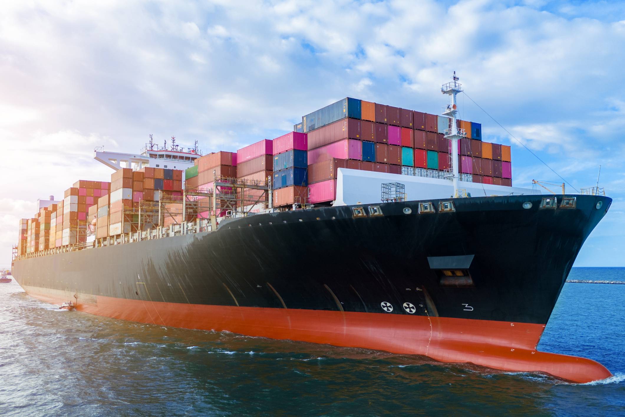 Container ship sailing through ocean waters.